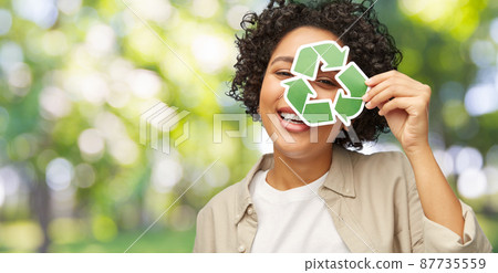 happy woman looking through green recycling sign happy woman looking through green recycling sign 87735559