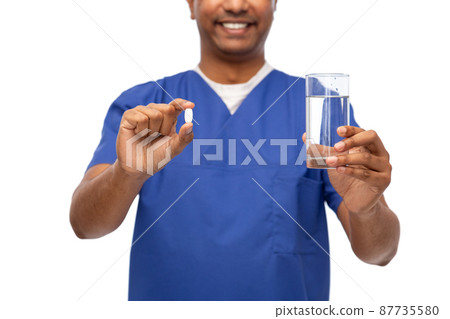 happy doctor or male nurse with medicine and water 87735580