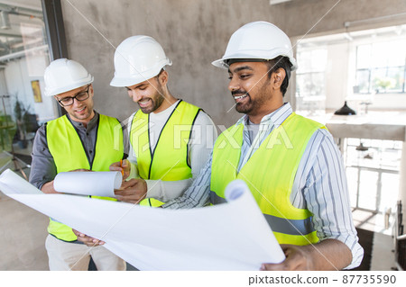 architects in helmets with blueprint at office architects in helmets with blueprint at office 87735590
