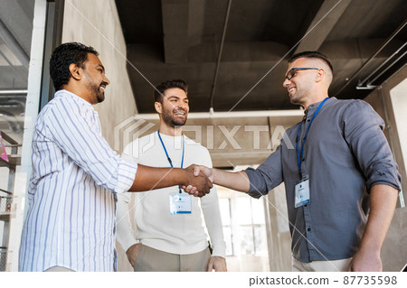 happy businessmen making handshake at office 87735598