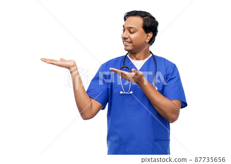 indian male doctor holding something on hand indian male doctor holding something on hand 87735656