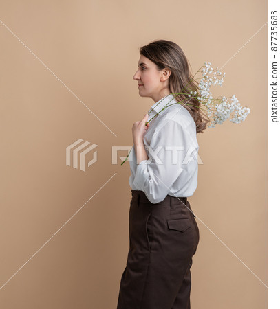 portrait of pensive woman holding branch of flower portrait of pensive woman holding branch of flower 87735683