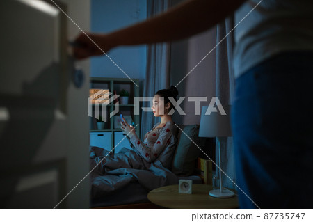 teenage girl with tablet pc in bed at night teenage girl with tablet pc in bed at night 87735747