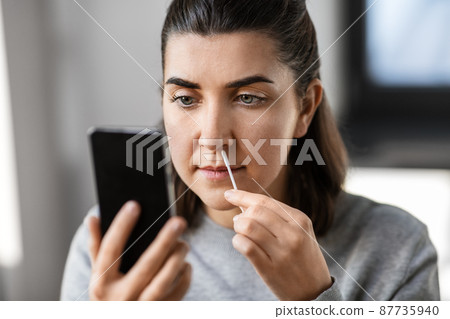 woman making self testing coronavirus test at home woman making self testing coronavirus test at home 87735940