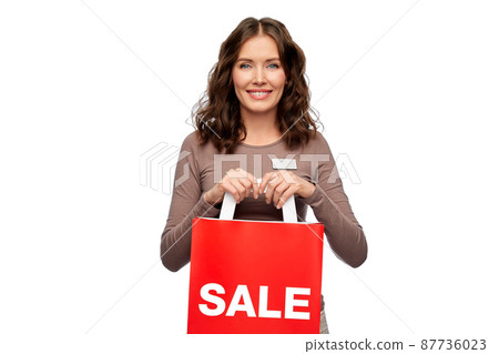 happy female shop assistant holding shopping bags happy female shop assistant holding shopping bags 87736023