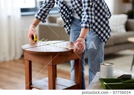 woman with ruler measuring table for renovation woman with ruler measuring table for renovation 87736034