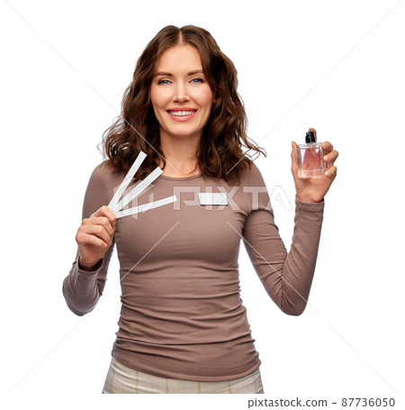 happy female shop assistant with perfume samples 87736050
