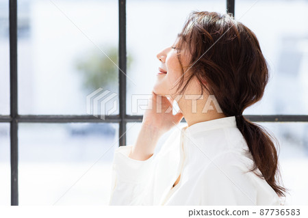 Woman by the window beauty image Woman by the window beauty image 87736583