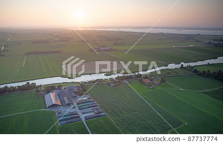 Agricultural landscape of Friesland, one of the northern provinces of the Netherlands - Friesland from above - Local farm Agricultural landscape of Friesland, one of the northern provinces of the Netherlands - Friesland from above - Local farm 87737774