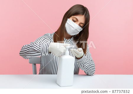 Hygiene, preventive measures during coronavirus quarantine. Woman employee pumping sanitizer, washing hands with soap, antiseptic gel. Disinfection at workplace, home office while covid-19 epidemic Hygiene, preventive measures during coronavirus quarantine. Woman employee pumping sanitizer, washing hands with soap, antiseptic gel. Disinfection at workplace, home office while covid-19 epidemic 87737832
