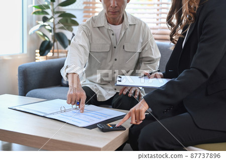 Cropped shot elderly man consulting with health insurance agent in office. Cropped shot elderly man consulting with health insurance agent in office. 87737896