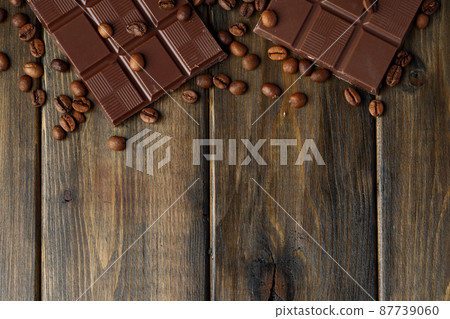 Roasted coffee beans with black chocolate close up Roasted coffee beans with black chocolate close up 87739060