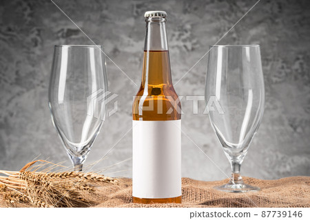 Beer bottle and beer glass against gray background 87739146