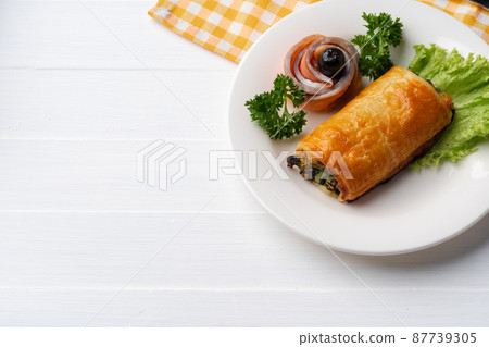Traditional Russian pie or patty on white plate 87739305