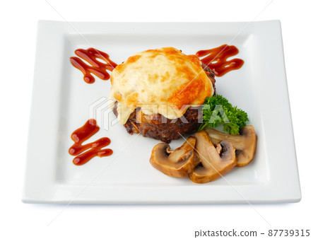 Meat with melting slice of cheese isolated on white background. Meat with melting slice of cheese isolated on white background. 87739315