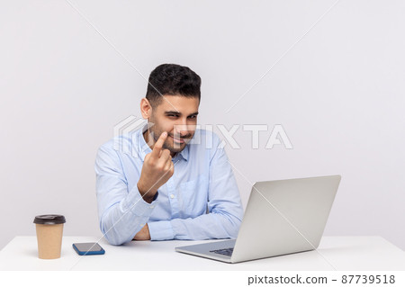 Come here to me. Happy successful male employee, hr manager sitting office workplace with laptop, making beckoning gesture, inviting to join company. indoor studio shot isolated on white background 87739518