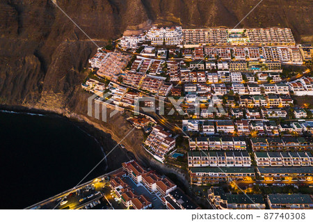 Top view of the houses located on the rock of Los Gigantes at sunset, Tenerife, Canary Islands, Spain 87740308