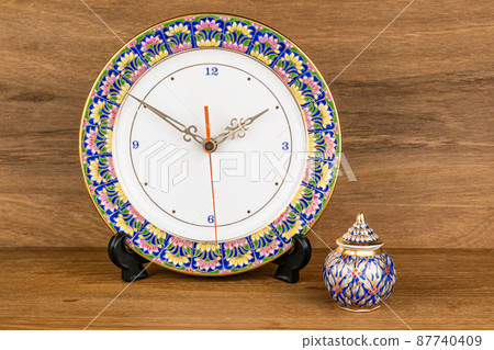 Closeup view of colorful Benjarong Clock and Benjarong  Jar, the famous souvenir from Thailand. 87740409