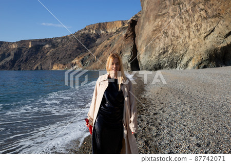 young beautiful woman dancing with a bottle of champagne on the beach young beautiful woman dancing with a bottle of champagne on the beach 87742071