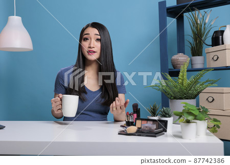 Portrait of social media influencer filming beauty podcast Portrait of social media influencer filming beauty podcast 87742386
