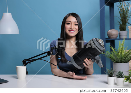 Portrait of asian creator vlogger reviewing studio light on camera Portrait of asian creator vlogger reviewing studio light on camera 87742405