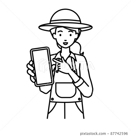 A farmer woman standing and pointing at her smartphone A farmer woman standing and pointing at her smartphone 87742596