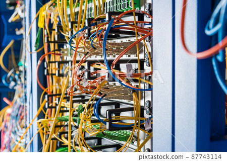 Server rack with fiber optic cables attached to front panel switch ports Server rack with fiber optic cables attached to front panel switch ports 87743114