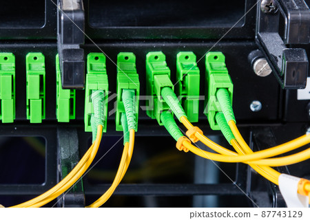 Fiber Optic cables connected to an optic ports - data switch in internet data center Fiber Optic cables connected to an optic ports - data switch in internet data center 87743129