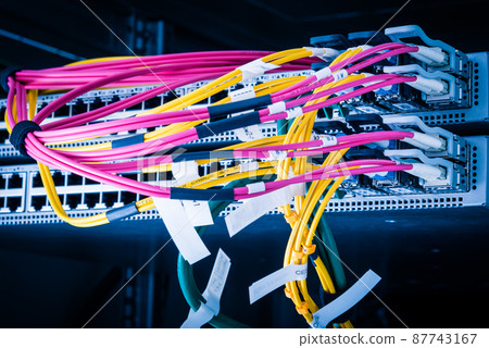 Fiber Optic cables connected to an optic ports - data switch in internet data center 87743167