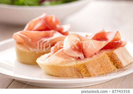Italian appetizer bruschetta with Parma ham on a plate Italian appetizer bruschetta with Parma ham on a plate 87743358