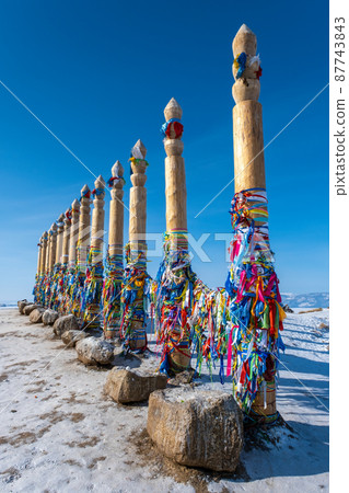 Wooden ritual pillars with color ribbons Wooden ritual pillars with color ribbons 87743843