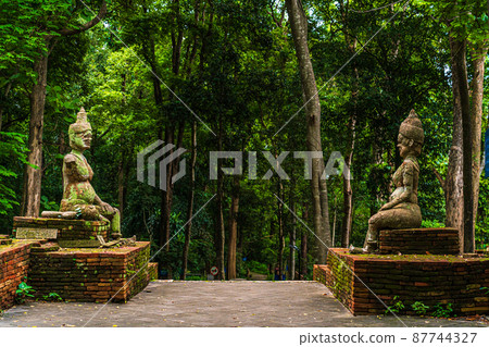 Ancient buddha figures Wat Umong Suan Puthatham is a Buddhist temple in the historic centre and is a Buddhist temple is a major tourist attraction with green forest nature in Chiang Mai,Thailand. Ancient buddha figures Wat Umong Suan Puthatham is a Buddhist temple in the historic centre and is a Buddhist temple is a major tourist attraction with green forest nature in Chiang Mai,Thailand. 87744327