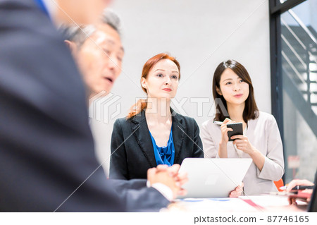 A woman interpreting at an international conference 87746165