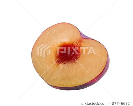 Half of smooth-skinned, purple plum fruit without kernel isolated on white background with copy space for text or images. Side view. Close-up. 87746682