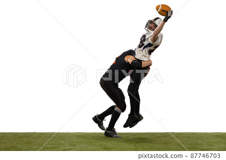 Two male american football players playing during sport match on grass flooring isolated on white background. Concept of sport, challenges, goals, strength. Poster, banner for ad 87746703