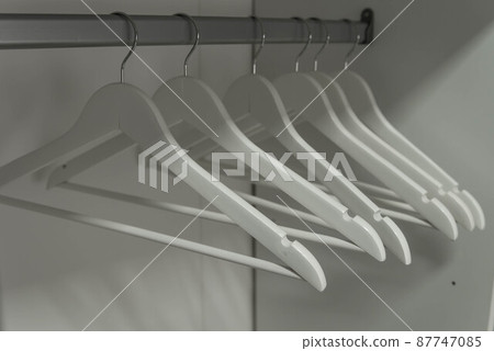 Colorful Wooden Cloth Hangers On Clothes Rail In White Wardrobe Stock  Photo, Picture and Royalty Free Image. Image 43816766.