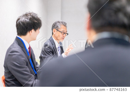 Business person having a meeting in a conference room Business person having a meeting in a conference room 87748163