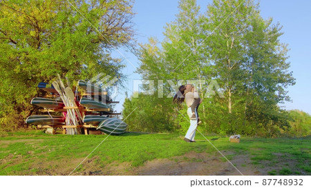 A happy family. The daughter runs to her mother in the forest park. happy family concept. Mom and daughter in the forest park. 87748932