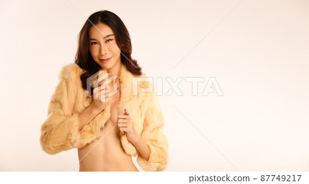 Nudity Woman poses fashion with fur jacket to cover her breasts and present hands arms with art Nudity Woman poses fashion with fur jacket to cover her breasts and present hands arms with art 87749217
