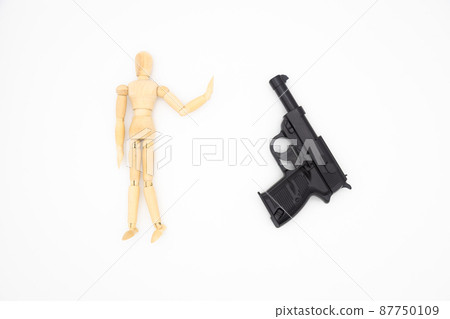 A drawing doll and a toy gun, an image against war, an image of eradicating crime 87750109