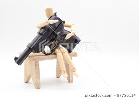 A drawing doll and a toy gun, an image against war, an image of eradicating crime A drawing doll and a toy gun, an image against war, an image of eradicating crime 87750114