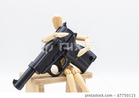 A drawing doll and a toy gun, an image against war, an image of eradicating crime A drawing doll and a toy gun, an image against war, an image of eradicating crime 87750115