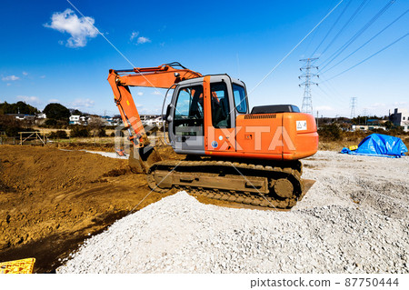 Construction work: Heavy equipment backhoe and clear blue sky Construction work: Heavy equipment backhoe and clear blue sky 87750444