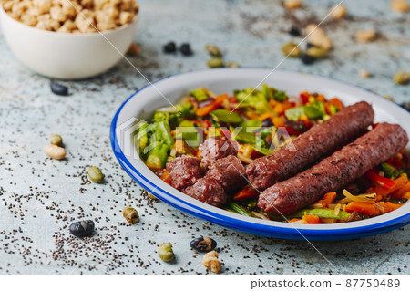 fried veggie sausages with grilled vegetables 87750489