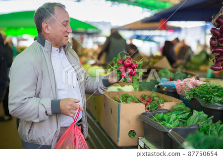 Man buying radish in market Man buying radish in market 87750654