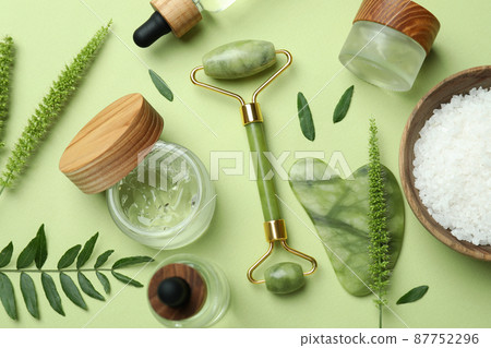 Skin care beauty concept with face roller on green background 87752296