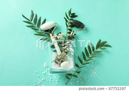 Skin care concept with face rollers on mint background 87752297