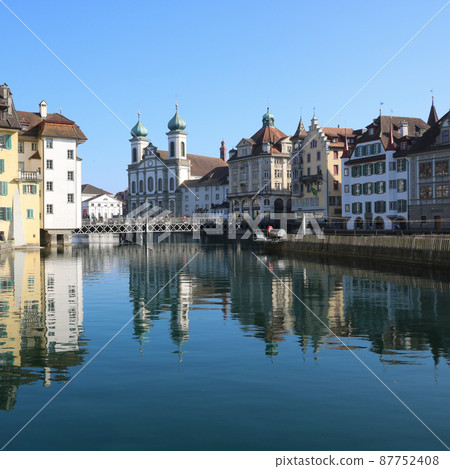 Houses and baroque Jesuit Church at the shore of the river Reuss, Lucerne. 87752408