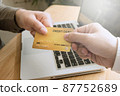 Woman picking credit card in wallet for shopping online. 87752689