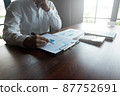 Businessmen are pointing numbers, graph, chart in business results. Business concept. 87752691